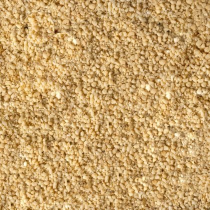 Aproximação de pó amarelo pálido fino e granulado, com textura grosseira e esfarelada a cobrir toda a imagem.