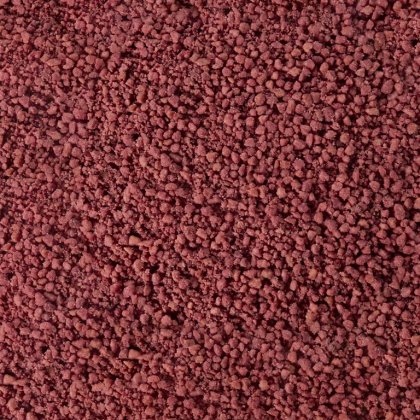 Textura de grânulos ou pó grosso castanho-avermelhado, semelhante a grãos minerais ou especiarias aglomerados.