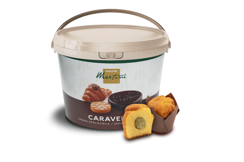 Balde grande de creme para barrar Master Martini Caravel junto a um muffin cortado recheado e um muffin inteiro.