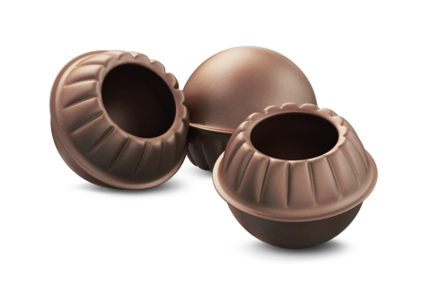Três cascas de chocolate redondas e vazias, com bordas onduladas e centro oco, sobre fundo branco.